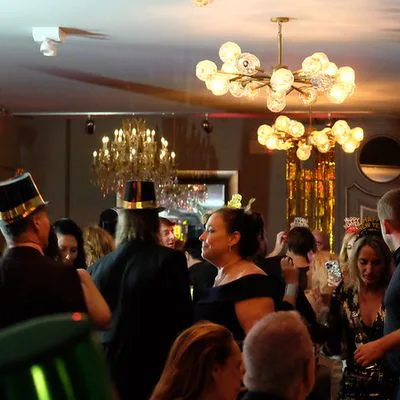 Guests in party hats on the dance floor