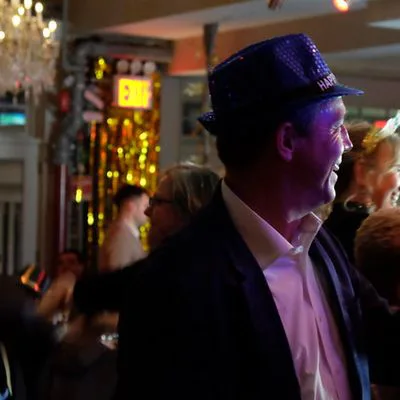 A guest in a sequinned hat