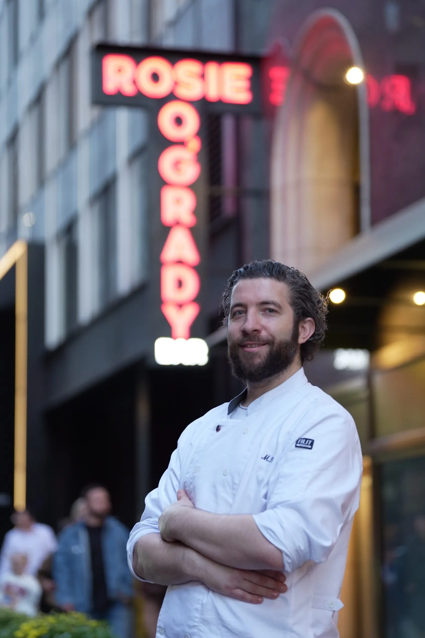 Executive Chef Michael Brogan outside Rosie O'Grady's, under the neon sign