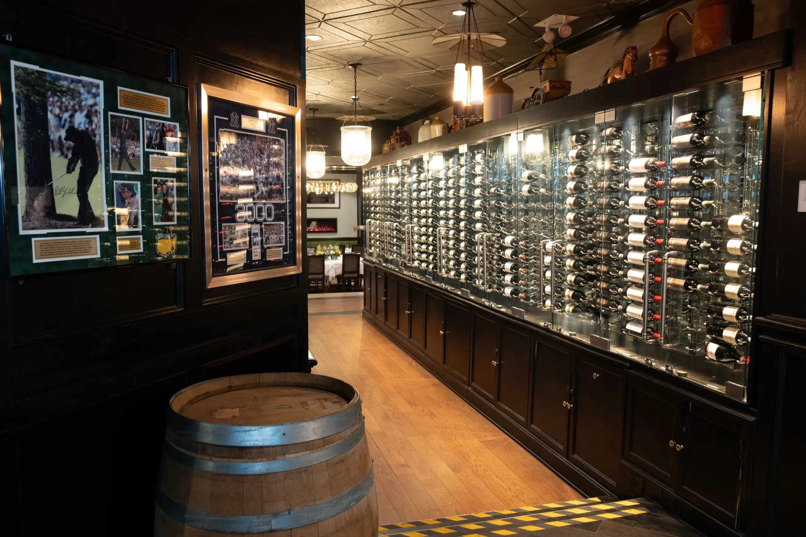 Wine wall, framed memorabilia and a barrel on the ground floor