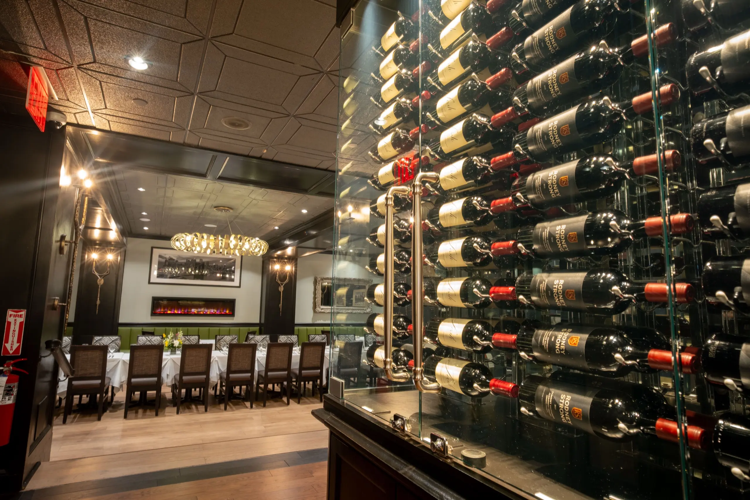 The glass wine wall, looking through to a dining room set for a party