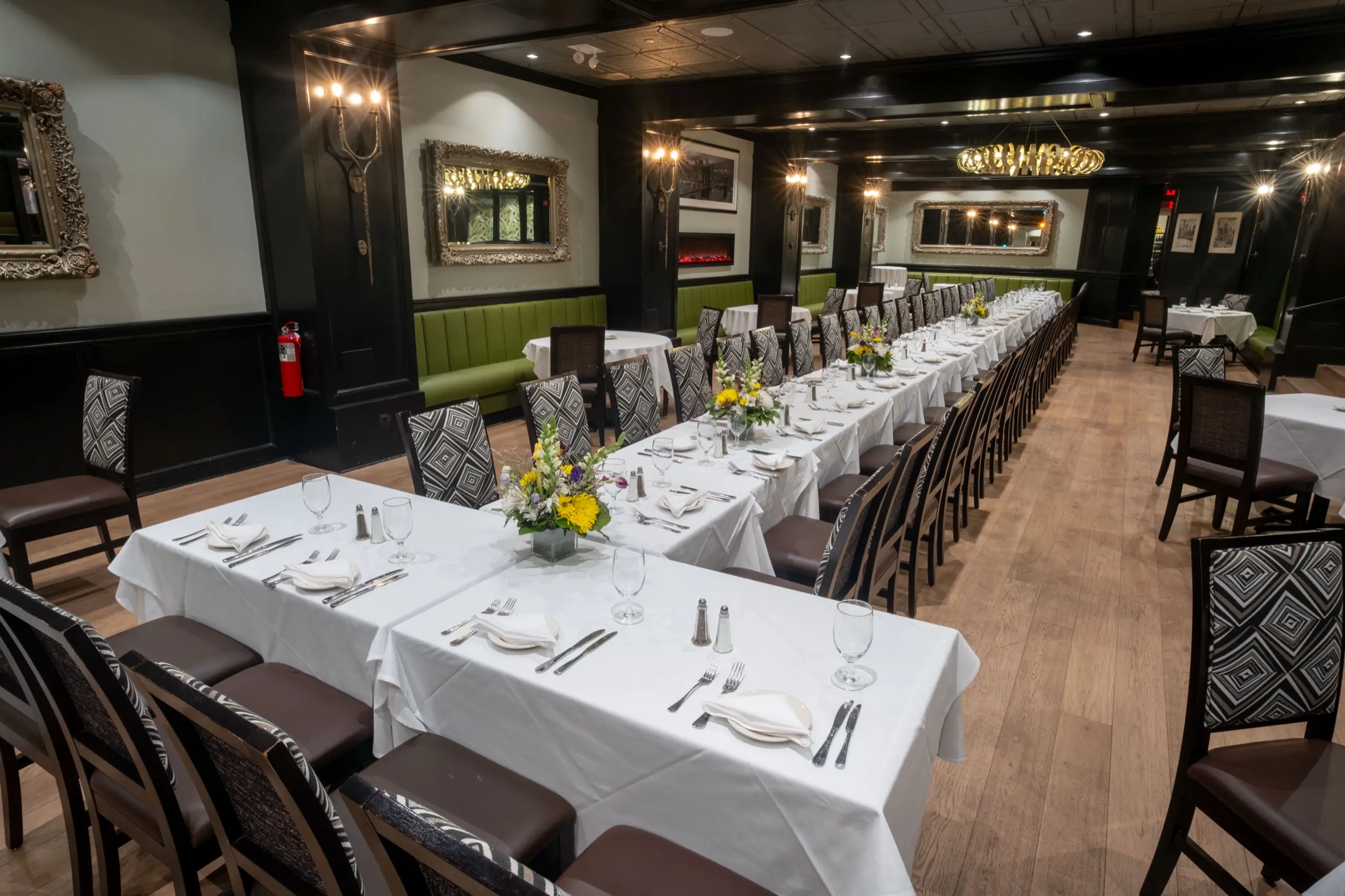 Main Hall set with long tables, green banquettes and gilt mirrors