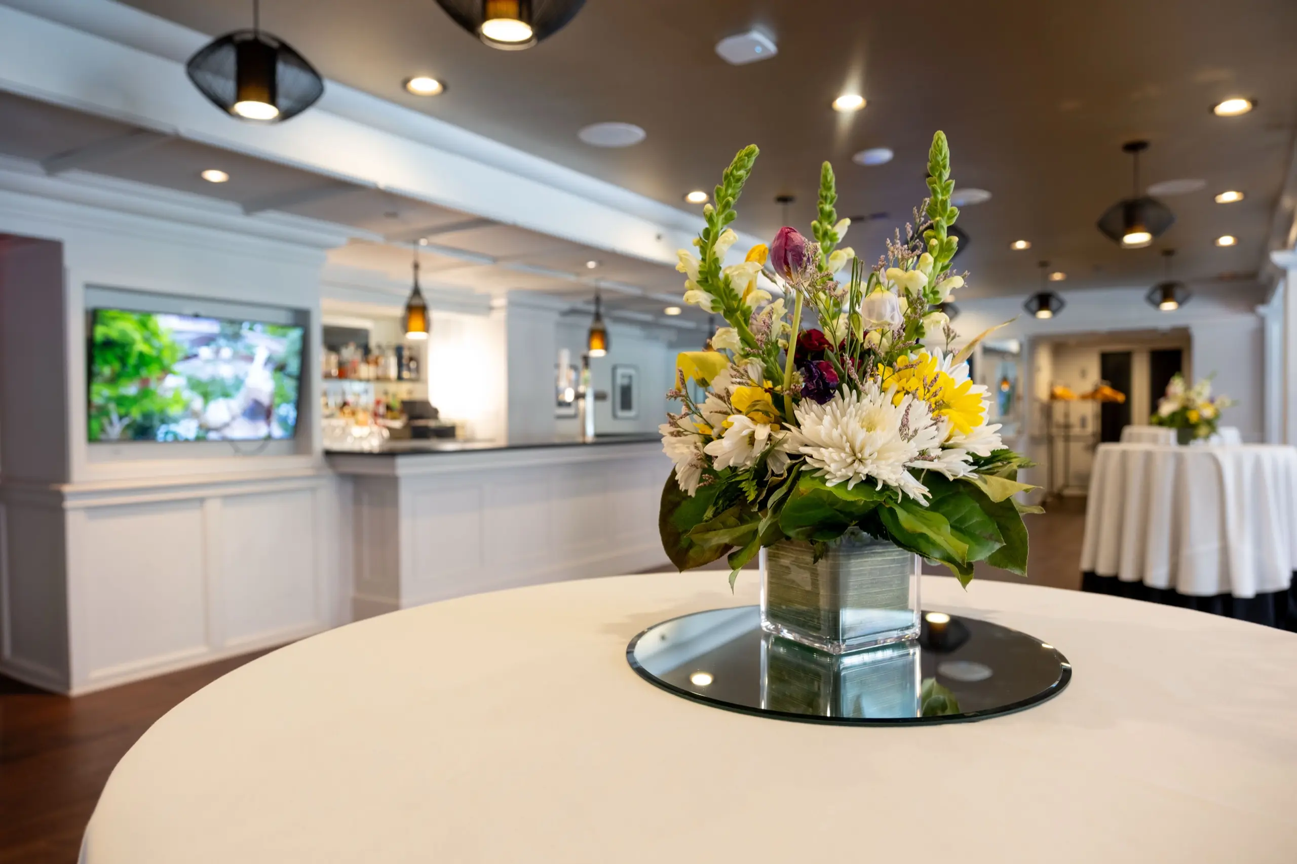 Manhattan Manor set for a reception, flowers on a cocktail table