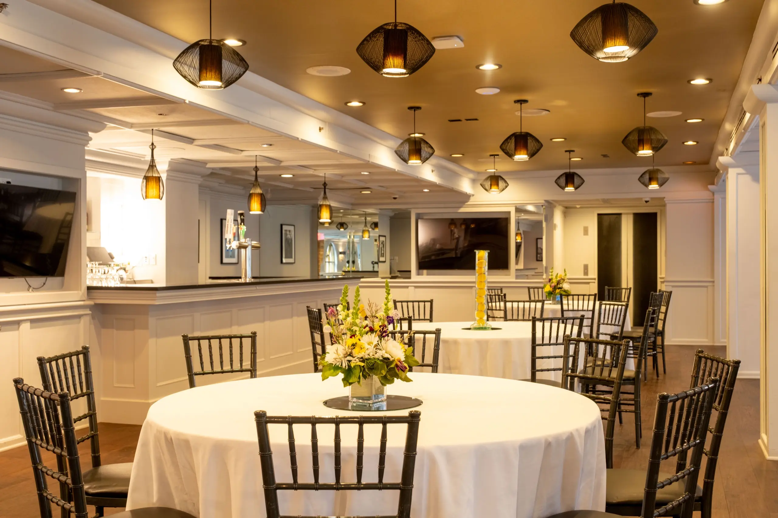 Manhattan Manor with round tables set under the pendant lights